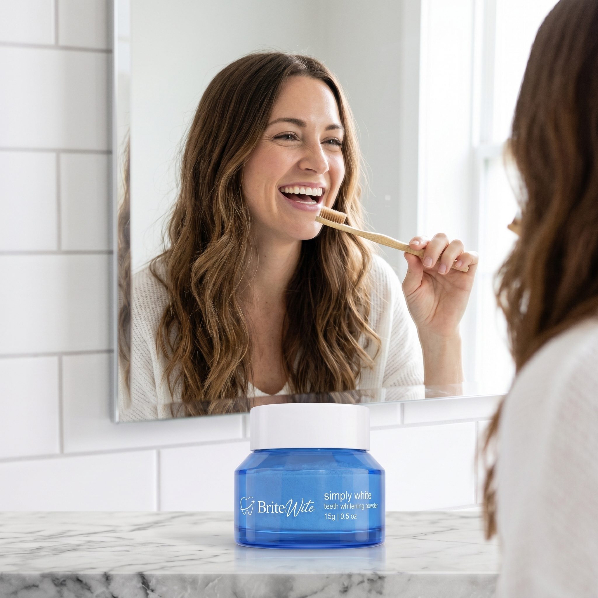 Woman brushing her teeth in a bathroom mirror with BriteWite Canam Manuals whitening powder, the kind of clip circulating on TikTok