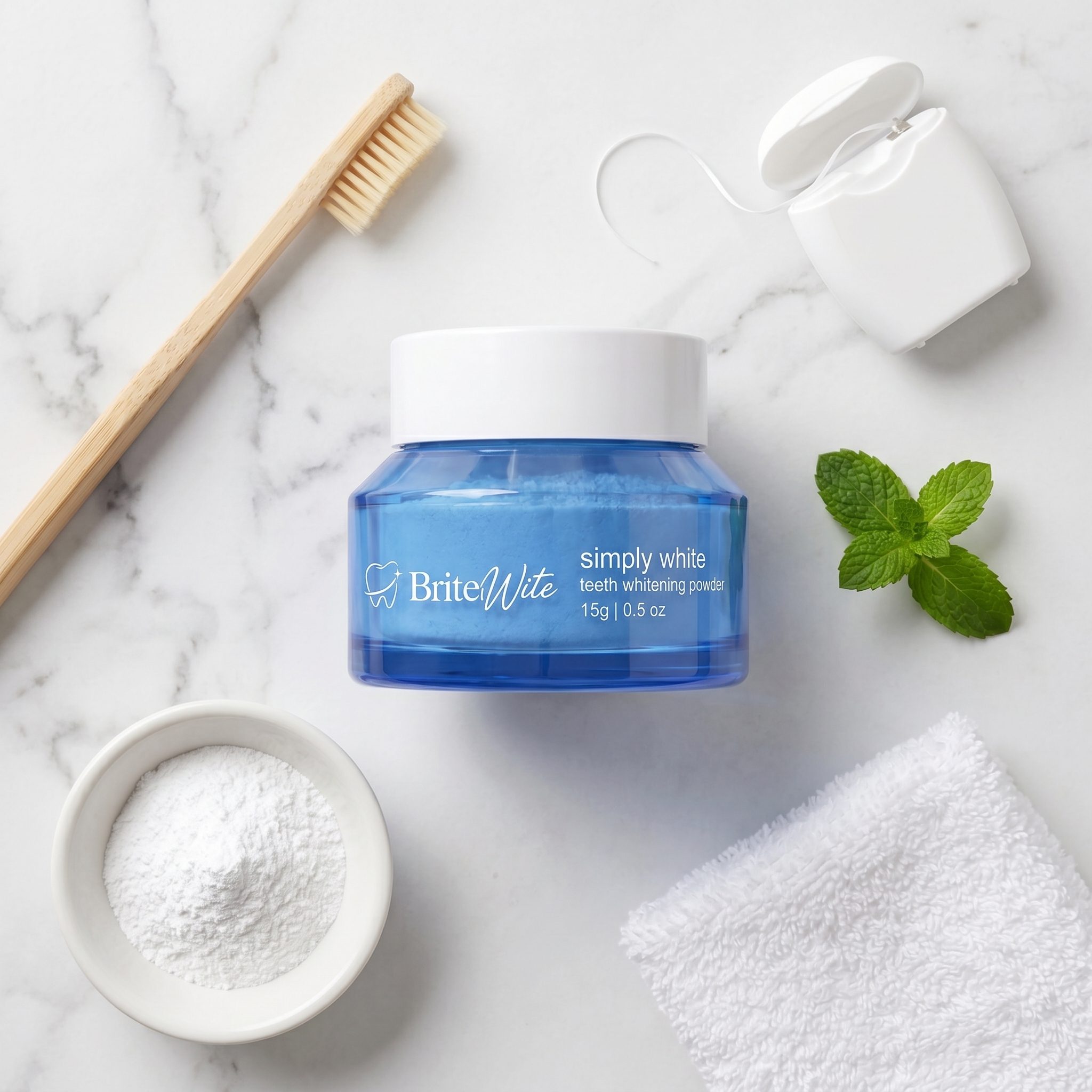 BriteWite Canam Manuals Whitening Powder styled with a bamboo toothbrush, floss and fresh mint